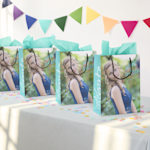 Shows an array of multi-coloured bags spread out like a fan with the words Tennis Club printed on them. 