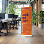 A lunch and learn retractable banner in an office setting.