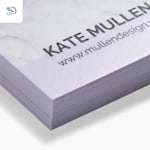A close-up of a stack of white matte business cards, with a 48-hour delivery icon in the corner.