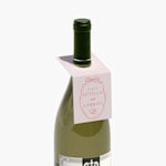 A wine bottle displaying a bottle neck tag.