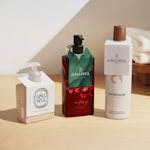 Three cosmetic bottles displaying bottle neck tags.