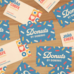 Designs para a frente e o verso de vários cartões de visita mate reciclados para uma loja de donuts.