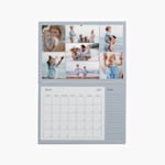 A pair of hands holding a personalised wall calendar that features a photo of a mother and baby. 
