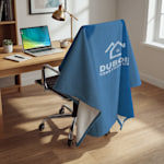 A blue custom sweatshirt blanket personalized for a business called Dubois Construction.
