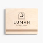 A wood print customized with the name and logo of a home goods boutique. 