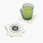 A square ceramic coaster set customized with the monogram M. 