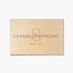A wood print customized with a monogram, family name, and year. 