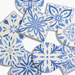Ceramic coasters in a variety of shapes customized with blue Spanish tile designs.  