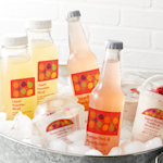 An icebox filled with different beverages, each featuring its own distinct and colorful label.