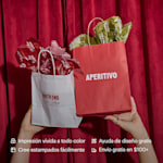 A pair of hands holding up two paper bags filled with tissue paper customized for an Italian restaurant. Highlighted benefits include full-color printing, free design assistance, free shipping and the ability to create your own tissue paper pattern.