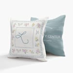 Two custom pillows, one printed with a monogram and the other with the logo and name of a wellness center. 