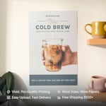 A bright yellow poster hanging on a brick wall promoting an art exhibition. Highlighted benefits include vivid printing, easy upload, more sizes and papers and fast, free shipping.