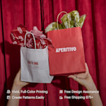 A pair of hands holding up two paper bags filled with tissue paper customized for an Italian restaurant. Highlighted benefits include full-color printing, free design assistance, free shipping and the ability to create your own tissue paper pattern.