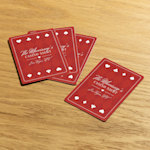 Playing cards customized for a casino night, laid out on a wooden table. 