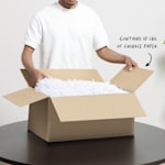 A man opening a cardboard shipping box packed with crinkle paper filler. 