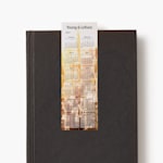 A 2027 calendar bookmark for an agency resting on a closed black book.