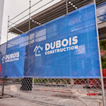 A horizontal mesh banner promoting a construction business.