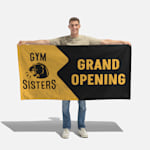 A wall flag promoting a construction business, displayed at the corner of a building.