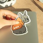 A custom die-cut sticker shaped like a dog, promoting a dog walking business.