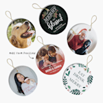 Six different Christmas ornaments featuring photos and text, side by side. An arrow points to the porcelain material. 