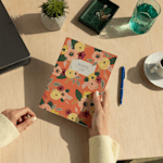 A custom wraparound spiral notebook with floral illustrations and a person's name on the cover.