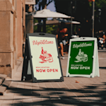 Water-fillable A-frames promoting a restaurant, displayed outdoors. One frame is black and one frame is white. 