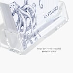 An acrylic business card holder holding business cards for a restaurant, with a note that they can hold up to 40 standard business cards.