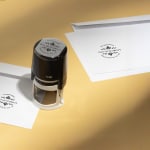 A round stamp from a florist being used to mark envelopes.