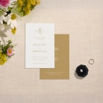 A custom wedding invite featuring a botanical-inspired monogram. 