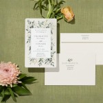   A botanical wedding invitation and a custom envelope featuring matching motifs. 