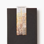 A 2026 calendar bookmark for an agency resting on a closed black book.