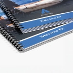 A stack of wire-bound reports and consulting materials for business services.