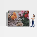  A woman standing next to a floral tension fabric display for scale.