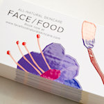 A stack of spot UV business cards, designed for a skin care business, is shown in close-up.