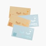 A front and back view of a metallic business card with a QR code for a spa.