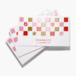 A stack of spot UV business cards for a creative studio.