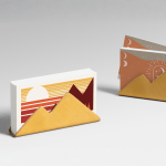 Two business card holders with business cards promoting travel businesses.
