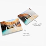 Two aluminium prints, both featuring landscape photos. There is text that reads that there are two material options, one being brushed aluminium and the other coated white aluminium.