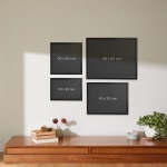 A collection of framed prints hung on a wall, each labeled by their size.