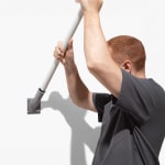 A man affixing a flagpole to its base.