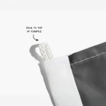 A close-up of a flag’s top string loop, with a note saying to attach this part to the flagpole.