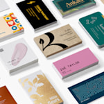 A vibrant collection of standard business card designs is arranged neatly on a white surface.