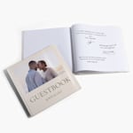 Two wedding guest books. One features a picture of the couple on the cover and the other is open to a page scribbled with notes from wedding guests.