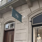 A building exterior featuring a custom wall-mounted banner promoting a coffee business.