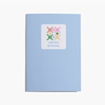 Light blue notebook with a United School logo sticker on the front cover.