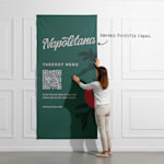 A fabric poster with a QR code promoting a restaurant being installed onto a wall.
