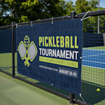 A horizontal mesh banner promoting a pickleball tournament.