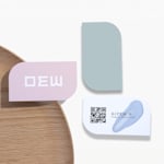 Leaf shaped name cards promoting a cosmetics business, with a QR code on the back.