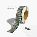 A return address label roll promoting a consultancy business. An arrow points to the total label count, which is up to 500 labels per roll.