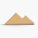 A front facing, empty golden business card holder.